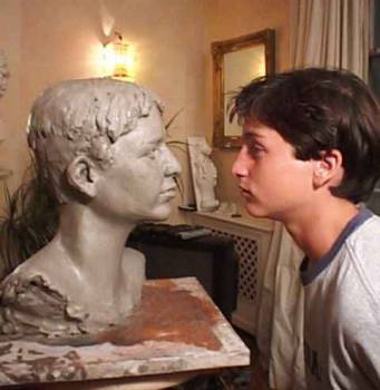 A young client face to face with his bust