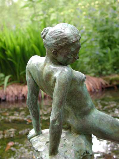 Rear view detail of Sitting Proud - a small figurative sculpture in bronze by sculptor Laury Dizengremel