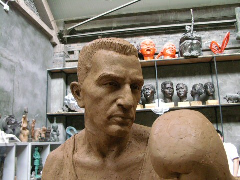 Face and boxing glove detail of the lifesize figure in clay